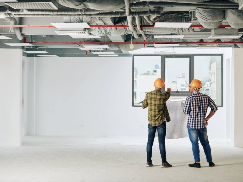 construction-engineers-with-blueprint-J3C4L4S.jpg